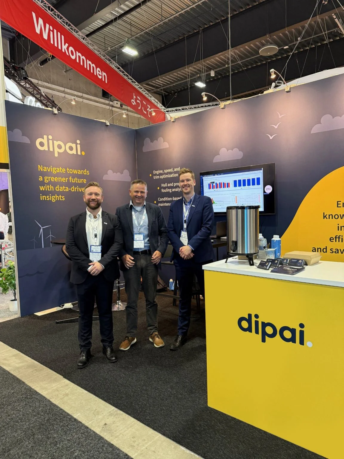 The Dipai team and visitors at an exhibition stand.
